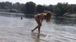 Hot girl blonde plays in the wet sand naked