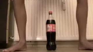 Small immature tries to ride a coke bottle