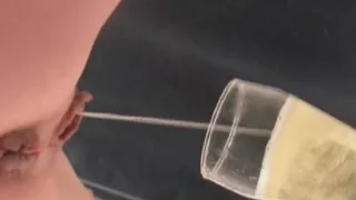 Blonde babe pissing on a bowl