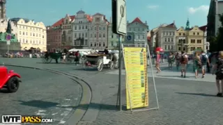 Hawt beauty shows melons in the midst of a lively square