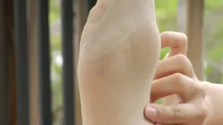 Asian babe wears stockings and shows off her feet