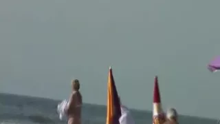 Voyeur watching a large-boobed mother I'd like to fuck on a beach