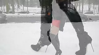 Hooker in high heels boots walking in snow +