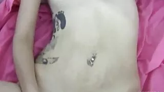 Tattooed coedl Bri plays witha toy