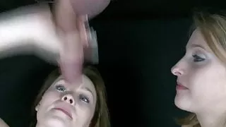 2 girls share a big dick through a gloryhole