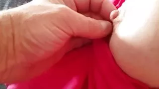 laying on the bed exposing her tit & nipple from her top