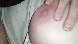 wife pinching her left nipple