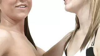 Gorgeous teen lesbians fuck with a dildo in bed