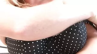 Gorgeous busty babe is on the bed wearing her colorful socks and her red higheals