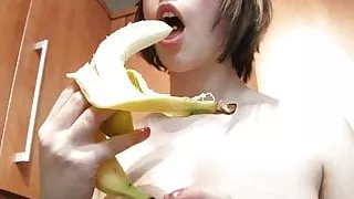 Louisa sucks off a banana wearing yellow lingerie in the kitchen