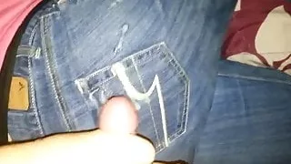 Woman jerking off man on her jeans
