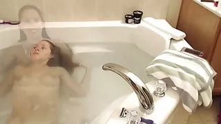 Webcam girl washes hair and shaves legs and pussy in bath
