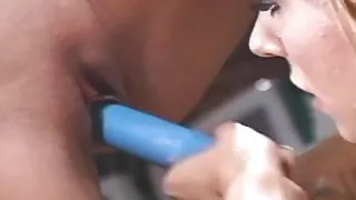 Two hot lesbians at a car garage dildo fuck each other