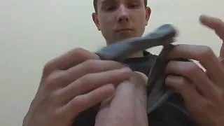 Hung twink Eryk is playing with his feet and big uncut cock