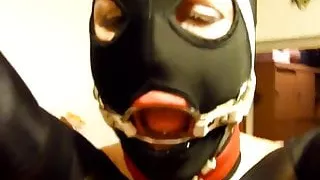 Putting giant penis gag in slave's slut ring gagged mouth