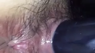 Hairy Japanese girl with a toy in her pussy