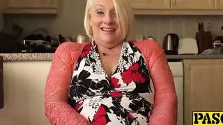 British mature blonde granny Carol fingers her wet pussy