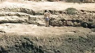 Slim Spanish Latina fucks herself on the beach