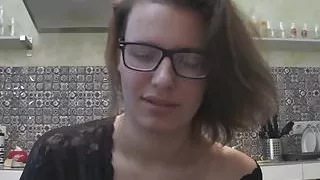 Solo girl with glasses chatting in the kitchen