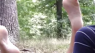 blonde showing feet in nature