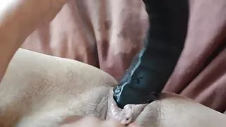 At play with her dildo