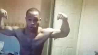 Black muscle flexing wearing a towel