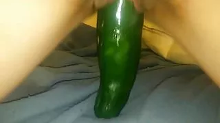 Petite brunette riding a huge cucumber