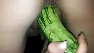 Brunette fucking a huge vegetable as dildo