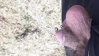 Pierced cock pissing outdoors