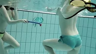 Girls swimming underwater and enjoying eachother