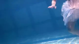 Bulava Lozhkova with a red tie and skirt underwater