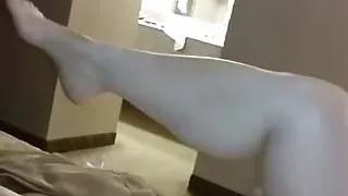 Rubbing oil on her legs