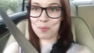 Girl in glasses farts in her car