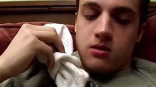 Tattooed twink gets a footjob before getting to blow cock