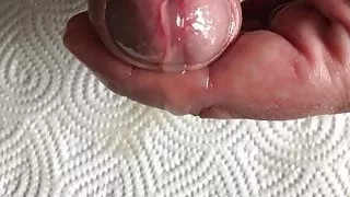 Closeup - Cum flows slow out of my oiled cockhead