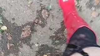 in red boots on a parking lot