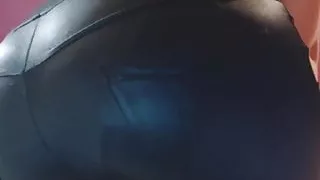 Cute girl in geek glasses farting in tight leather pants