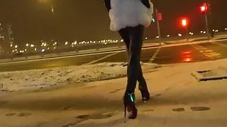 Girl walking in hot leather leggins and high heels outdoor