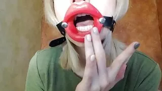 Zooming in red lips open mouth gag for dildo-blowjob.