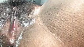 Black chick fingering her creammy pussy