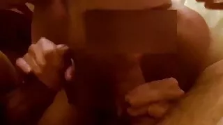 MILF gives a blowjob to two guys