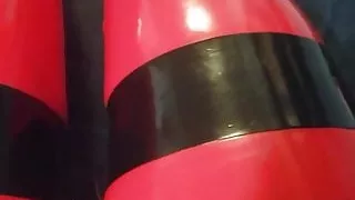 Shiny red latex rubber stockings closeup