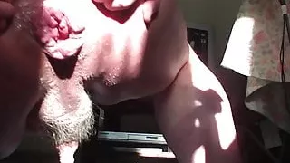 Anal gape beer bottle in sunshine