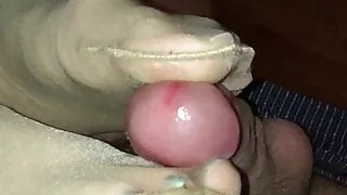 Slowly draining his balls with her nylon stockinged feet