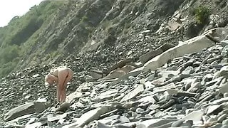 Skinny nude woman by the sea