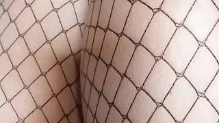 Teasing in fishnet stockings