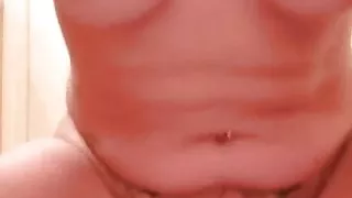 Tattooed MILF squirts while riding dildo