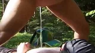 Mistress pisses on her slave in the forest.