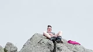 Zoey masturbating in public high up on a rock in the harbor