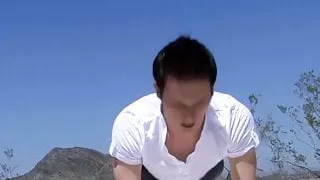 Cute young man stretches in the outdoors and then jerks off